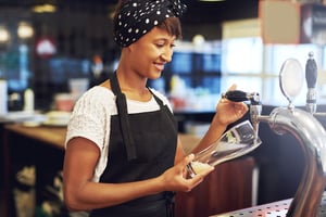 african-american-bartender-pouring-a-glass-of-beer-PJSNYYH