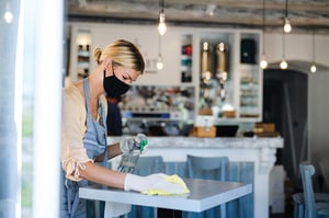 coffee-shop-woman-owner-working-with-face-mask-and-485K6XZ