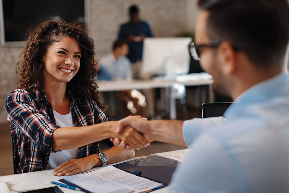 Worker Shaking Hands With Manager After Performance Review