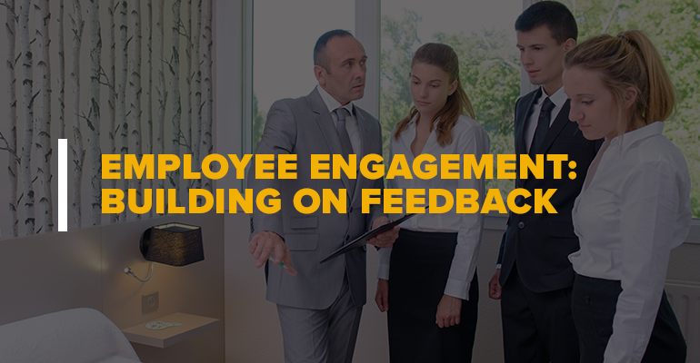 Hotel Manager and Workers With Text: Employee Engagement Building on Feedback